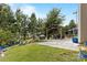 Landscaped backyard featuring a pergola, seating area, and mature trees at 116 Maggie Dr, Mount Holly, NC 28120