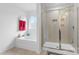 Bright bathroom featuring a soaking tub and separate shower with glass door at 116 Maggie Dr, Mount Holly, NC 28120