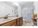 Bathroom features a double vanity with modern fixtures and a shower with a stylish curtain at 116 Maggie Dr, Mount Holly, NC 28120
