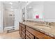 Bathroom featuring double vanity with granite countertop and a glass shower at 116 Maggie Dr, Mount Holly, NC 28120