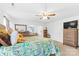 Spacious bedroom with a ceiling fan, TV, dresser, and comfortable bed with patterned bedding at 116 Maggie Dr, Mount Holly, NC 28120