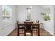 Bright dining area featuring a wooden table set, natural light, and a view to the backyard at 116 Maggie Dr, Mount Holly, NC 28120