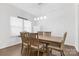 Formal dining room with a large wooden table and elegant lighting at 116 Maggie Dr, Mount Holly, NC 28120