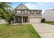 Charming two-story home features a well-maintained lawn, front porch, and two-car garage at 116 Maggie Dr, Mount Holly, NC 28120