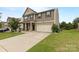 Charming two-story home with a large driveway and well-manicured lawn at 116 Maggie Dr, Mount Holly, NC 28120