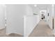 Bright hallway featuring neutral colors, plants on the railing and views into other rooms at 116 Maggie Dr, Mount Holly, NC 28120