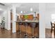 Open kitchen featuring a breakfast bar with stools, wooden cabinets, and stainless steel appliances at 116 Maggie Dr, Mount Holly, NC 28120