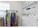 Clean laundry room featuring modern appliances, shelving and space for clothes at 116 Maggie Dr, Mount Holly, NC 28120