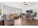 Inviting living room with hardwood floors, comfortable seating, a fireplace, and large windows at 116 Maggie Dr, Mount Holly, NC 28120