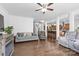 Open-concept living room showcasing hardwood floors and a view of the kitchen and staircase at 116 Maggie Dr, Mount Holly, NC 28120