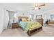 Bright main bedroom with ceiling fan, large bed, nightstands, and two windows at 116 Maggie Dr, Mount Holly, NC 28120