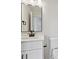 This bathroom has a modern vanity with a square black framed mirror, white counter top, and black hardware at 1172 Springlake Rd, York, SC 29745