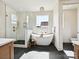 Luxurious bathroom features a soaking tub, glass enclosed shower, brass fixtures, and modern design at 1172 Springlake Rd, York, SC 29745