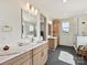 Bright bathroom with dual sink vanity, framed mirror, and modern gold fixtures, with a glass-enclosed shower at 1172 Springlake Rd, York, SC 29745