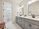 Bathroom featuring double sinks with gray cabinets, modern fixtures, and a white marble-tiled floor at 1172 Springlake Rd, York, SC 29745
