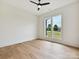 Minimalist bedroom featuring hardwood floors, a ceiling fan, and large windows with a neighborhood view at 1172 Springlake Rd, York, SC 29745