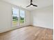 Bright bedroom with hardwood floors, ceiling fan, and large windows with views of the outdoors at 1172 Springlake Rd, York, SC 29745