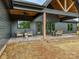 An inviting covered patio provides both a lounge area and a dining space, perfect for outdoor relaxation and entertaining at 1172 Springlake Rd, York, SC 29745