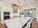 Spacious kitchen with an expansive island, pendant lighting, stainless steel appliances, and modern white cabinetry at 1172 Springlake Rd, York, SC 29745