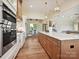 Open kitchen boasts stainless steel appliances, marble counters, a central island, and adjoins living and dining areas at 1172 Springlake Rd, York, SC 29745