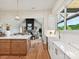 Open floorplan with kitchen island, farm sink, stainless appliances, and view to the living room at 1172 Springlake Rd, York, SC 29745