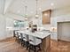 Gourmet kitchen with white cabinets, large island, pendant lighting, stainless appliances, and eat-in bar at 1172 Springlake Rd, York, SC 29745
