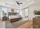 Main bedroom features a tray ceiling, ceiling fan, natural light, and ensuite bathroom with barn door entry at 1172 Springlake Rd, York, SC 29745