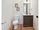 Charming powder room features a wood vanity with marble countertop, modern fixtures, and framed art at 1172 Springlake Rd, York, SC 29745