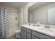 Well-lit bathroom with a double sink vanity and a shower-tub combo with modern fixtures at 13025 Cinnamon Fern Ln, Charlotte, NC 28227