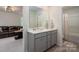 Bathroom with double vanity, modern fixtures, and tile flooring at 13025 Cinnamon Fern Ln, Charlotte, NC 28227
