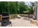 Relaxing wooden deck with seating and grill perfect for outdoor entertaining and enjoying nature at 13025 Cinnamon Fern Ln, Charlotte, NC 28227