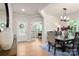 Elegant dining room with hardwood floors, stylish light fixture, and easy access to other rooms at 13025 Cinnamon Fern Ln, Charlotte, NC 28227