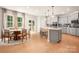 Eat-in kitchen boasts modern cabinetry, lighting, stainless appliances, and sunny breakfast nook at 13025 Cinnamon Fern Ln, Charlotte, NC 28227