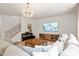 Bright living room with a large sofa, entertainment center, and stairs leading to another floor at 13025 Cinnamon Fern Ln, Charlotte, NC 28227