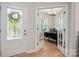 Bright home office with French doors, hardwood floors, and a large desk with modern decor at 13025 Cinnamon Fern Ln, Charlotte, NC 28227