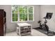 Bright office space featuring a desk, large window, and exercise bike at 13025 Cinnamon Fern Ln, Charlotte, NC 28227
