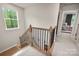 Staircase with wood stairs, metal railing, and window with view to outside at 13025 Cinnamon Fern Ln, Charlotte, NC 28227
