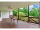Covered back porch with wood floors, a ceiling fan, and a beautiful view of the trees at 132 Homeplace Ln, Statesville, NC 28625
