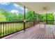 Relaxing covered back porch with wood floors and views of beautiful green trees at 132 Homeplace Ln, Statesville, NC 28625