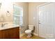 Bright bathroom featuring tile floors, a toilet, and vanity at 132 Homeplace Ln, Statesville, NC 28625
