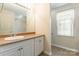 Bright bathroom featuring a vanity with a white sink, a large mirror and natural light at 132 Homeplace Ln, Statesville, NC 28625