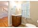 Cozy bathroom featuring a vanity with wood cabinetry, a framed oval mirror, and lots of natural light at 132 Homeplace Ln, Statesville, NC 28625