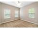 Bedroom featuring neutral carpet, three windows and a ceiling fan at 132 Homeplace Ln, Statesville, NC 28625