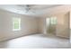 Bright, carpeted bedroom with neutral walls, two windows allowing lots of natural light, and a ceiling fan at 132 Homeplace Ln, Statesville, NC 28625