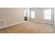 Carpeted bedroom with view to bathroom and plenty of natural light at 132 Homeplace Ln, Statesville, NC 28625