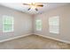 Cozy bedroom with neutral carpet, three windows and a ceiling fan at 132 Homeplace Ln, Statesville, NC 28625
