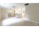 Spacious bonus room featuring neutral walls and carpet, with a partial wall and staircase in view at 132 Homeplace Ln, Statesville, NC 28625