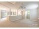 Spacious carpeted bonus room with neutral walls, including a partial wall and bright, sunny windows at 132 Homeplace Ln, Statesville, NC 28625