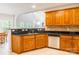 Kitchen featuring tile floors, oak cabinets, stainless steel dishwasher, and granite countertops at 132 Homeplace Ln, Statesville, NC 28625