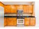Kitchen boasting wooden cabinets, stainless steel oven and microwave and tile backsplash at 132 Homeplace Ln, Statesville, NC 28625
